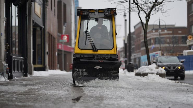 جرّافة تزيل طبقة سميكة من الجليد عن الرصيف اليوم في وسط مدينة تروا ريفيير في مقاطعة كيبيك.