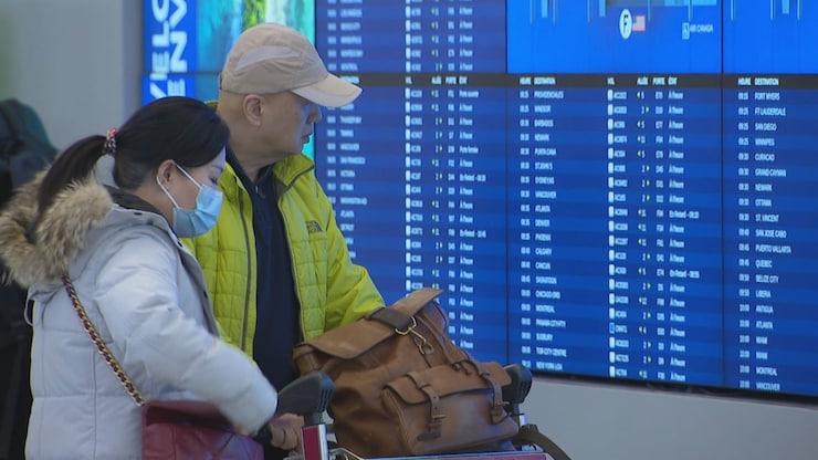 Two travellers are shown here at Toronto's Pearson International Airport. 