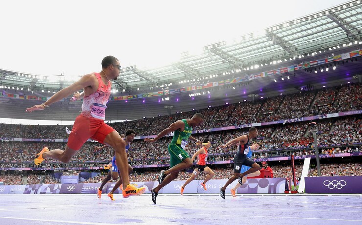 Sprinters crossing the finish line at the Olympics.