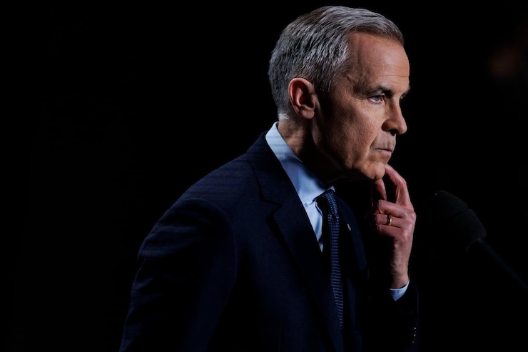 Mark Carney takes questions from reporters.