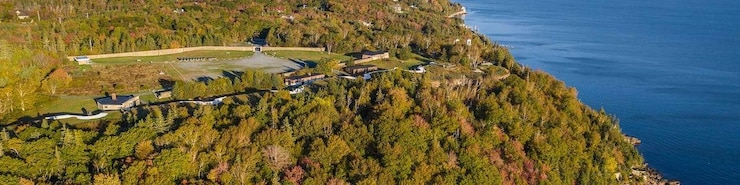 18th century fortifications on a hill covered with trees in autumn. The fort is overlooking the sea.