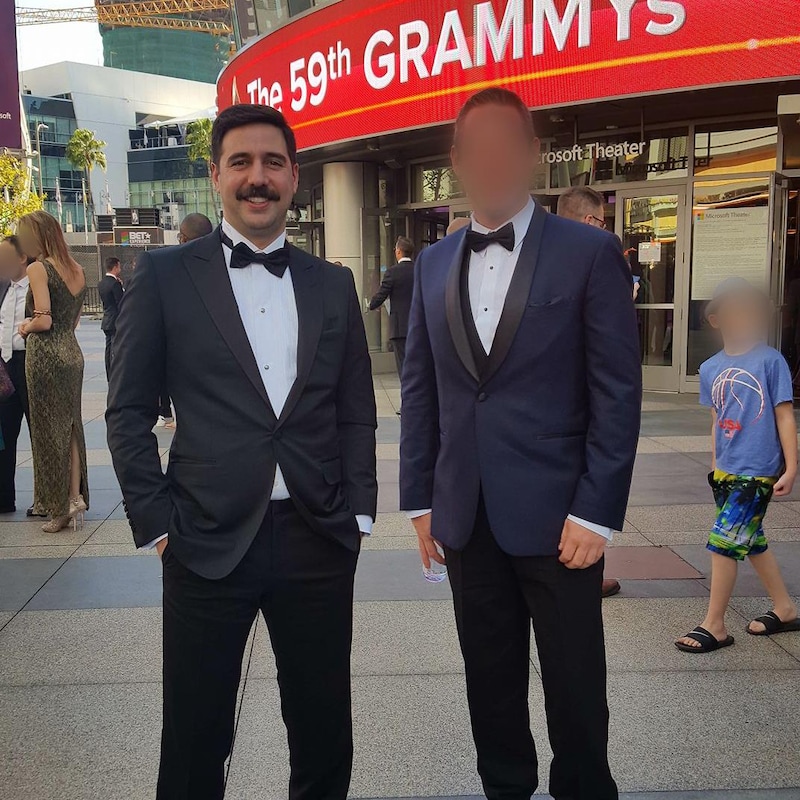 Philip Keezer and a man with a blurred face outside the Microsoft Theater in Los Angeles, where the Grammys gala is being held.