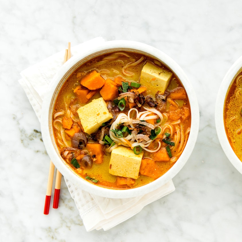 Deux bols côte à côte contenant de la soupe au tofu aux patates douces et cari.