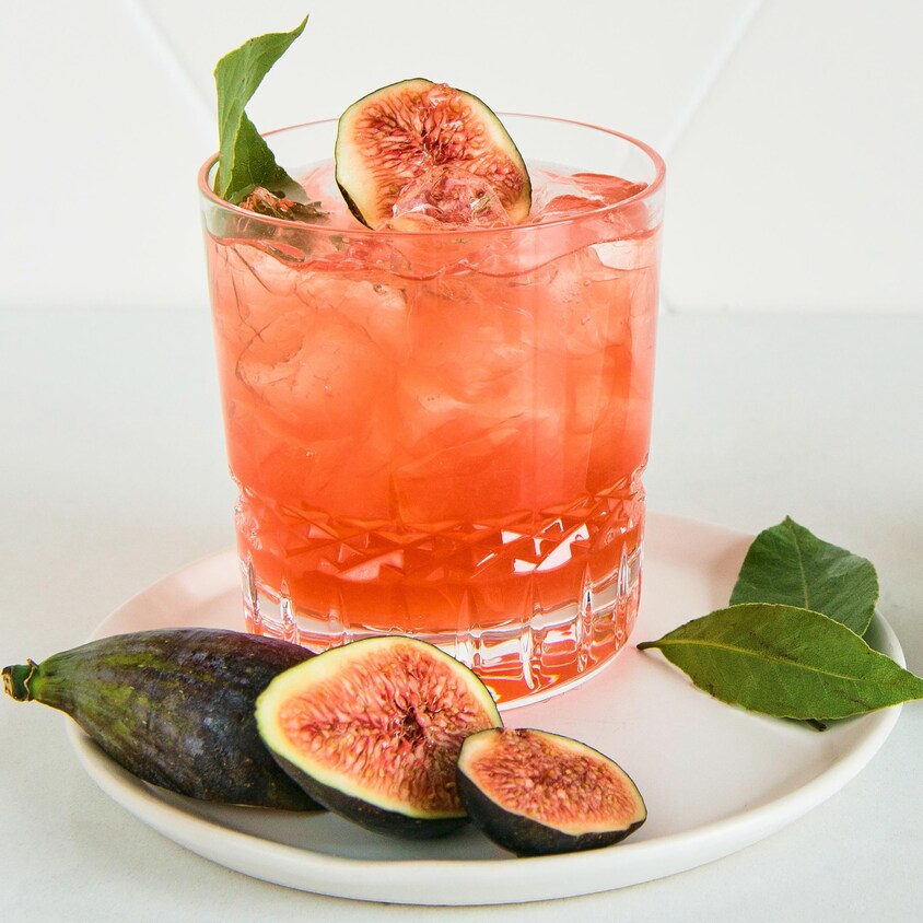 Un cocktail orangé accompagné de figues.