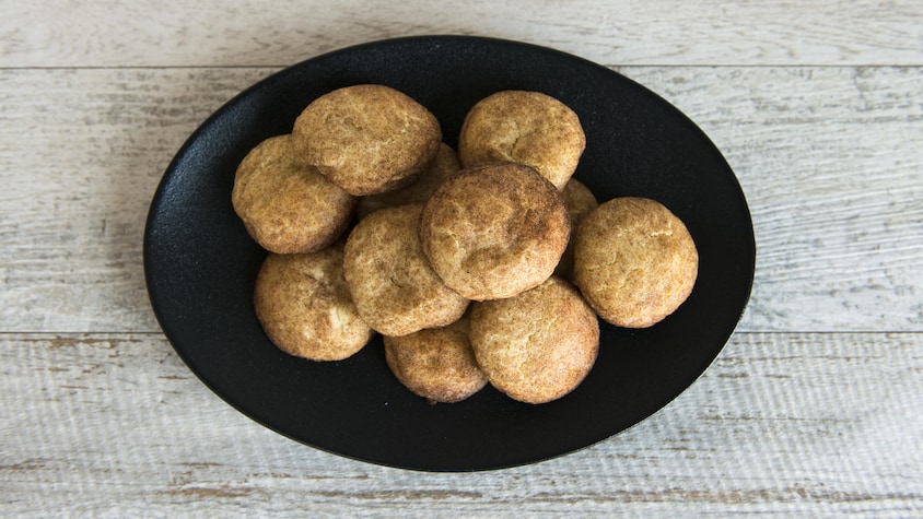 Une douzaine de biscuits sont amoncelés dans une assiette.