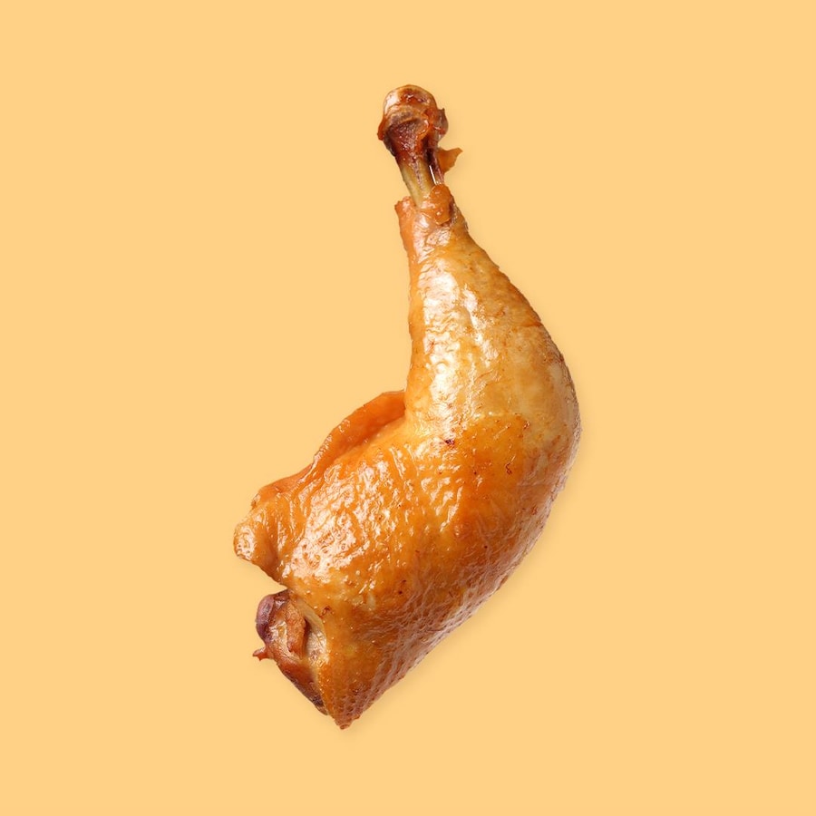 Une cuisse de poulet rôti sur un fond jaune.
