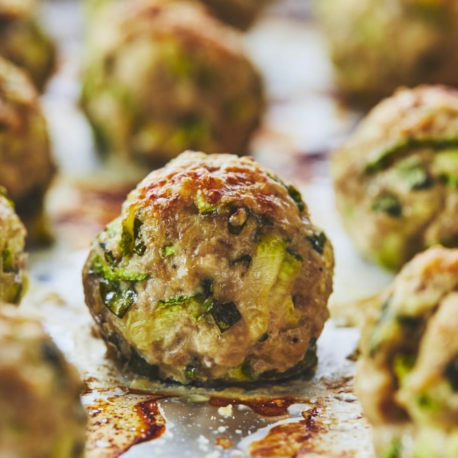 Des boulettes de dinde à la courgette sur une plaque de cuisson.