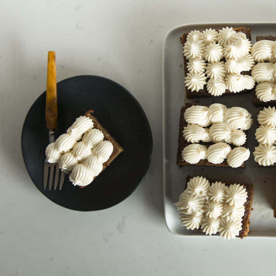 Un plateau avec des morceaux de gâteau avec du crémage et une assiette avec une portion.