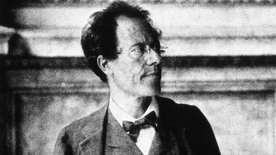 Old black and white photo of the man looking to his left.