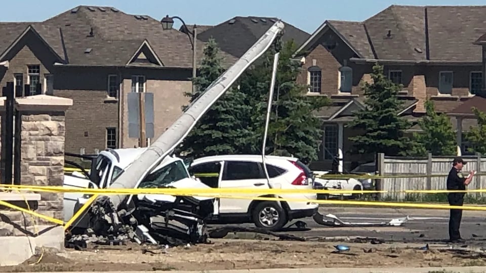 A vehicle was crushed under the pole at the scene of the accident.