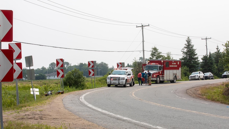 Les premiers secours - pompiers et ambulanciers - sont placés dans un virage à Saint-Gabriel-de-Valcartier. La signalisation indique un virage dangereux.