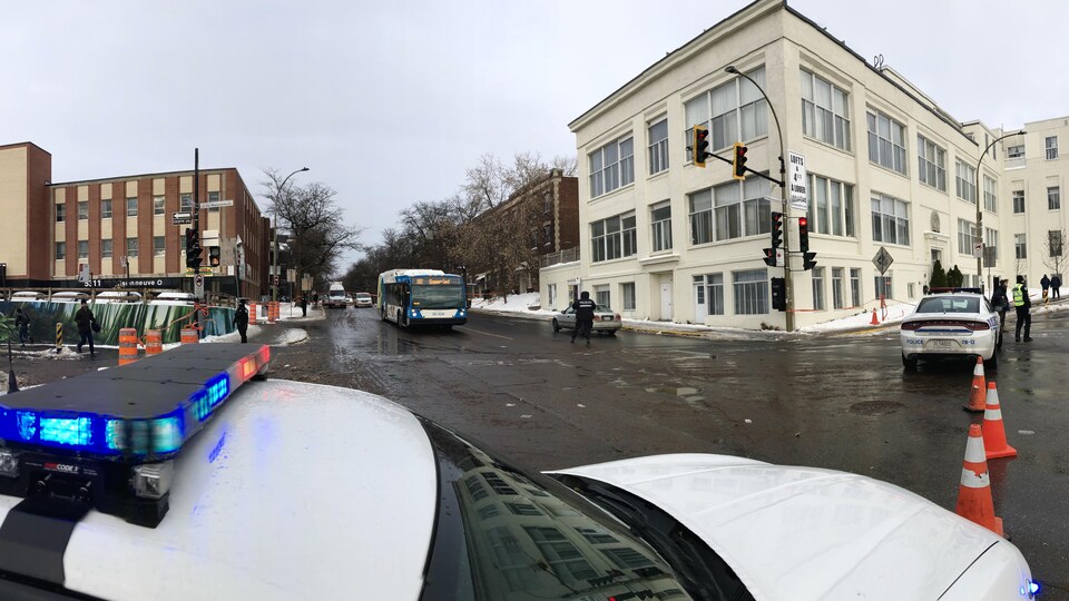 Deux voitures de police bloquent une intersection à Montréal.