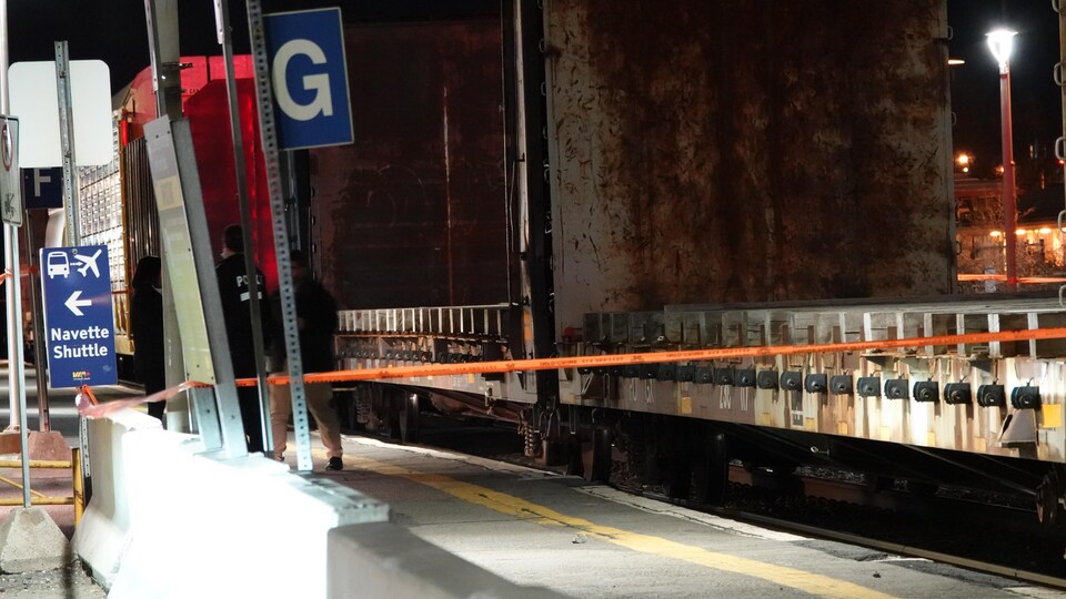 An orange tape marks the location of the incident on the railroad. 
