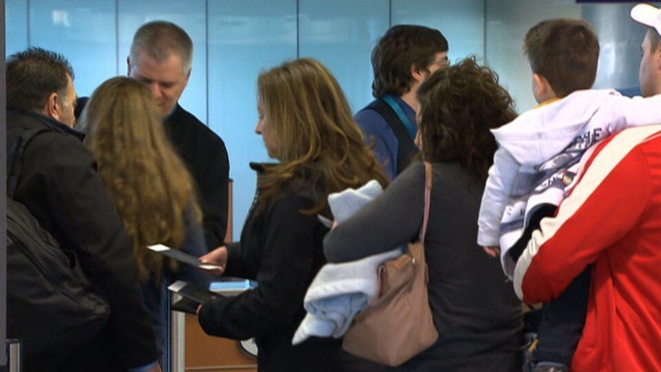Des Passagers attendent d'embarquer dans un avion à l'aéroport Pierre-Elliott-Trudeau.