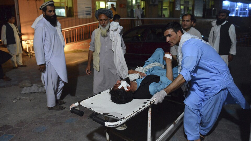 Un blessé transporté sur une civière en Afghanistan.
