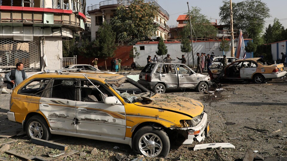 Des voitures et des bâtiments soufflés par une explosion.