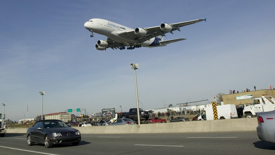 Un Airbus A380 sur le point de se poser à Montréal-Trudeau survole l'autoroute.