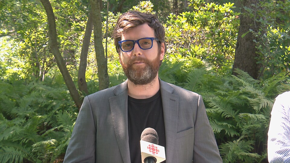 Alex Tyrrell devant une forêt.
