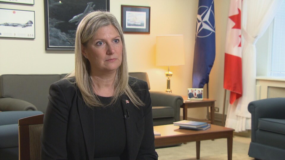 Leona Alleslev sitting in a chair in her office.
