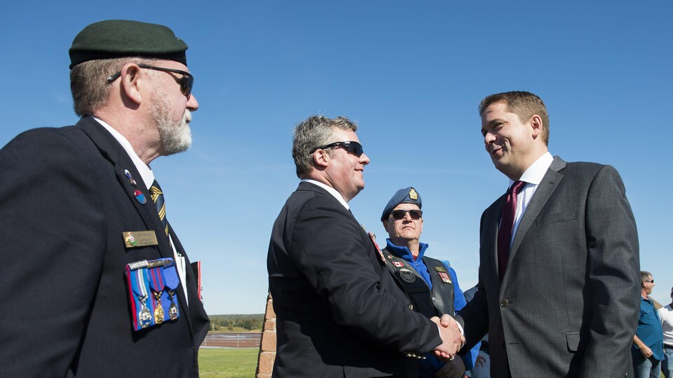 Andrew Scheer serre les mains de vétérans.