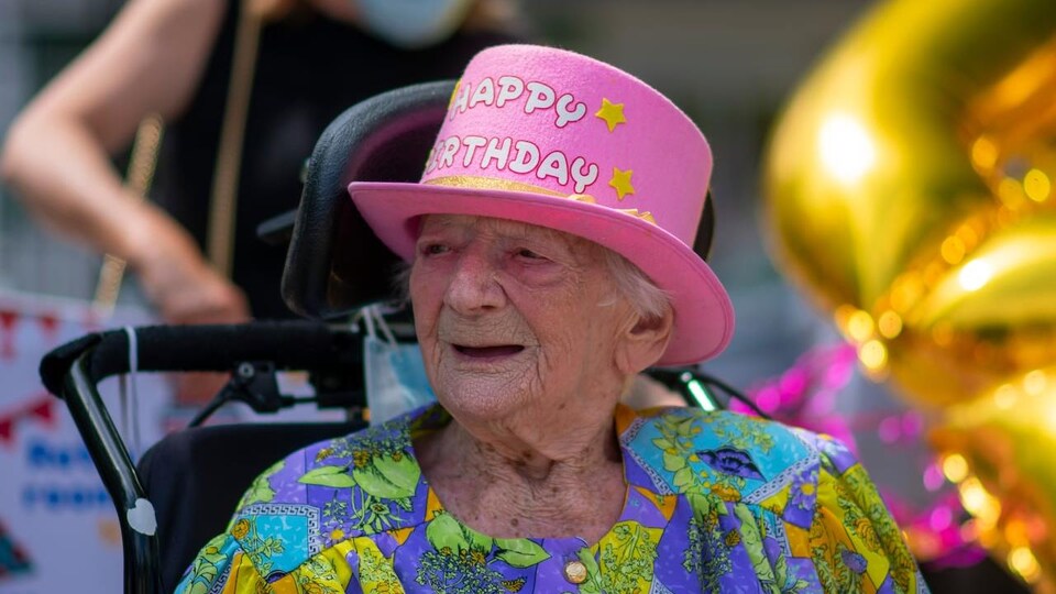 La photo d'une dame qui porte un chapeau rose.