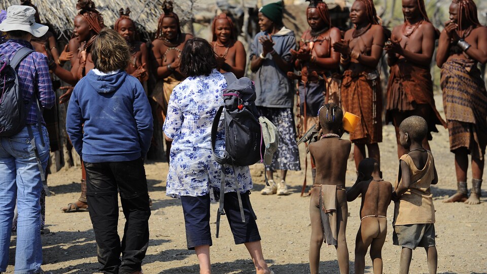 Des touristes assistent à une danse de femmes dans un petit village de Namibie.