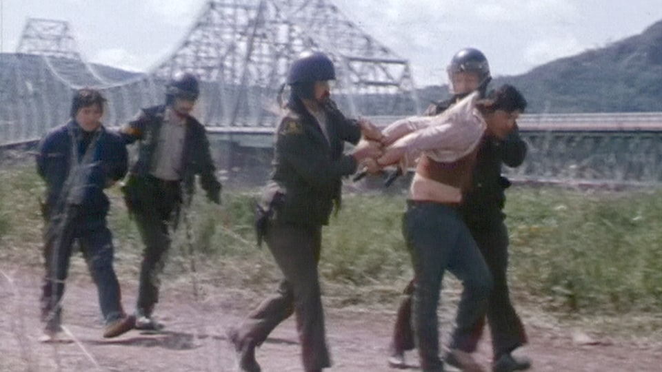 Deux Mi'gmaq sont immobilisés par les policiers devant le pont interprovincial.