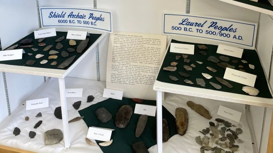 Des objets faits de roches exposés dans un présentoir.