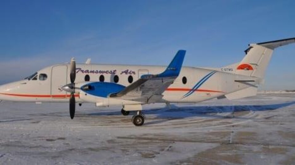 Un petit avion dehors à l'aéroport en hiver.