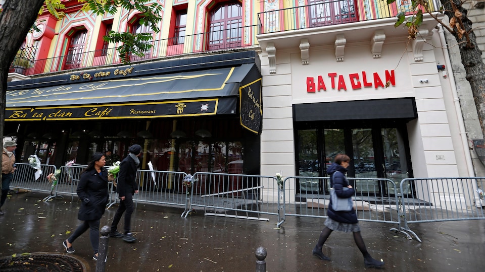 In Paris, passersby walk in front of Bataclan, a year after an attack that left dozens dead in 2015.
