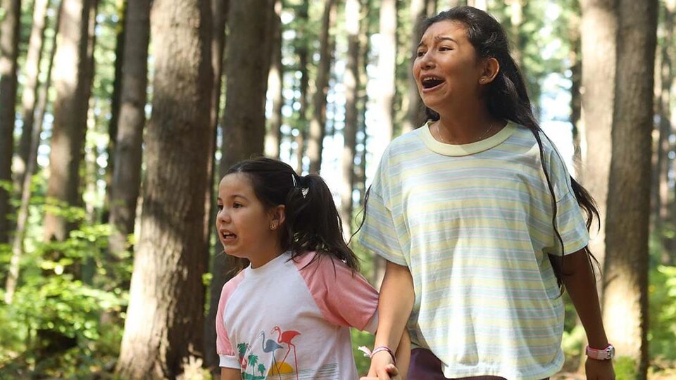 Two young women in the woods.