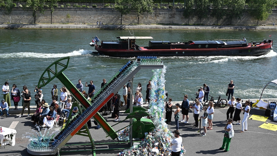 An installation unloads plastic onto a quayside on the Seine in Paris.