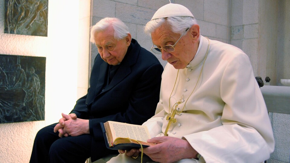 Le pape Benoît XVI (à droite), qui a quitté ses fonctions en février 2013, prie avec son frère Mgr Georg Ratzinger dans sa chapelle privée au Vatican, le 14 avril 2012. 
