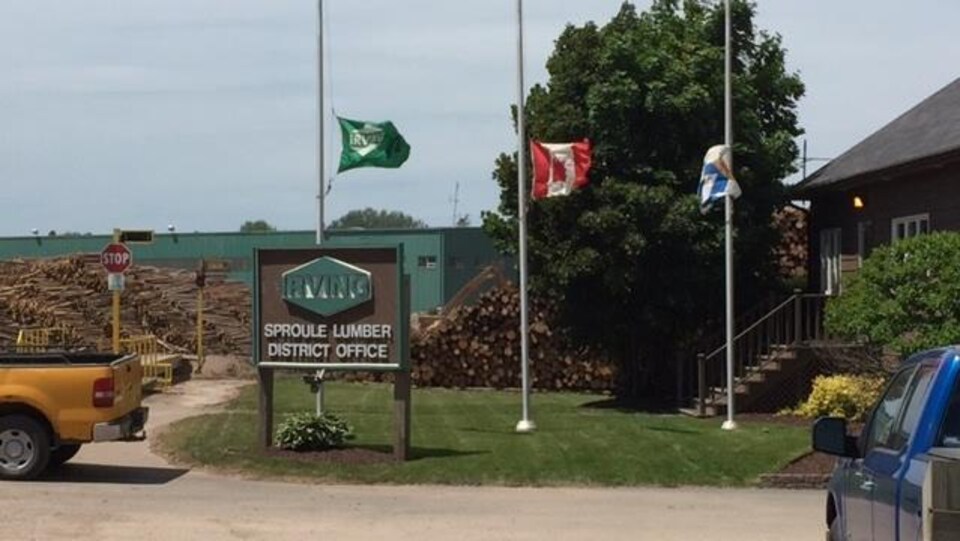Les drapeaux d'Irving, du Canada et de la Nouvelle-Écosse en berne devant les bureaux de l'usine.
