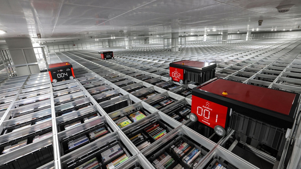 Wheeled machines rotate in a circle above the books.