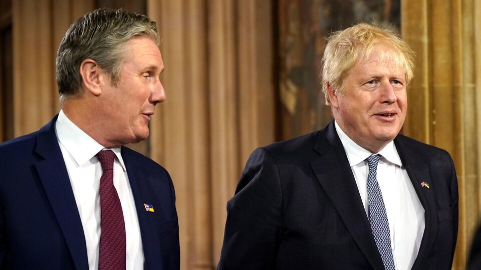 British Prime Minister Boris Johnson was accompanied by Labor Opposition Leader Keir Starmer smiling.