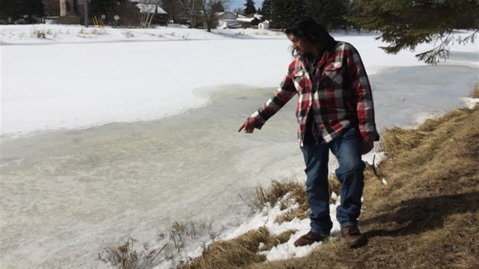 Brad DeBungee was standing on the bank of the river.