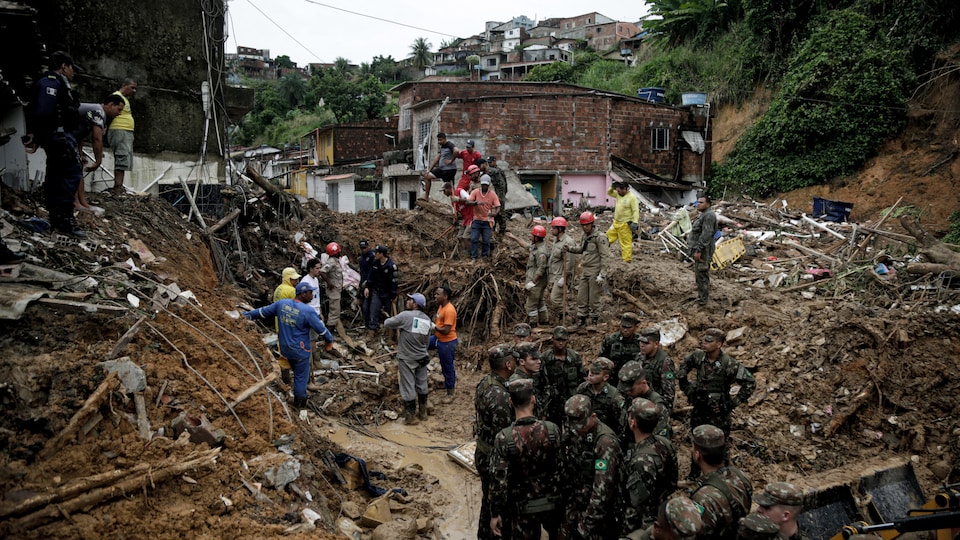 Soldiers, firefighters and residents searched for the victims in piles of debris and mud.