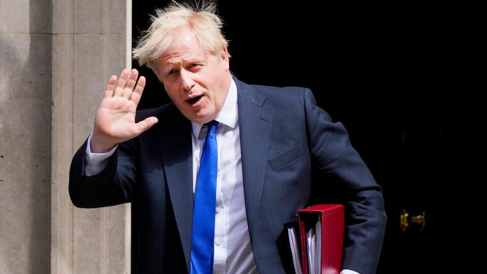 L'ancien premier ministre Boris Johnson salue de la main alors qu'il marche.