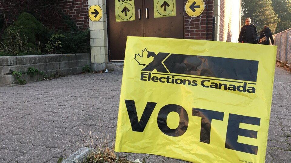 Une affiche d'Élections Canada devant un bureau de vote en Ontario.