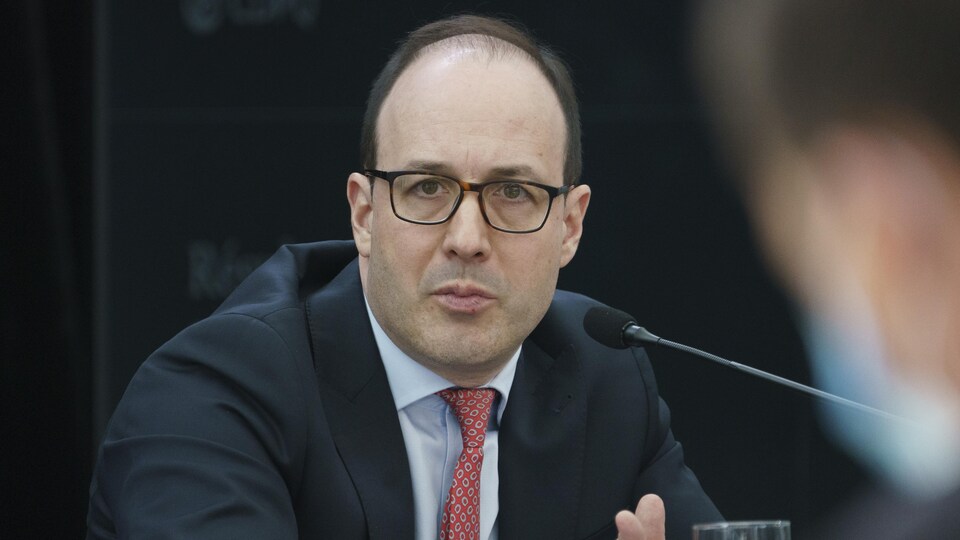 Close-up of Charles Emond at a press conference.