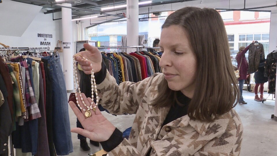 Une femme tient un collier.

