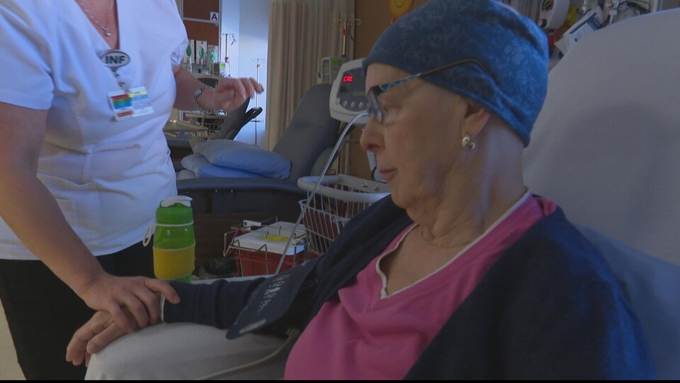 A lady is receiving chemotherapy treatment in the hospital. 