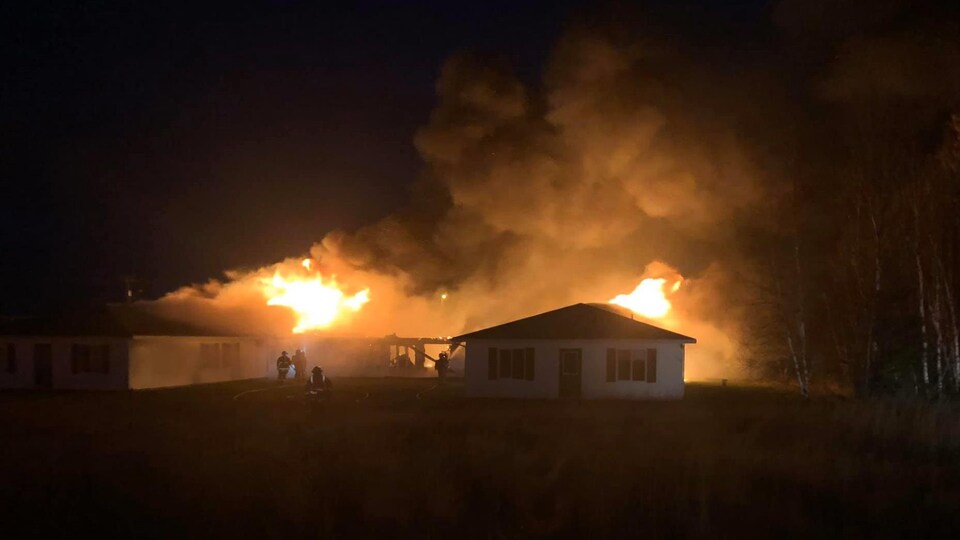 Large fires break out on the roof of the building.