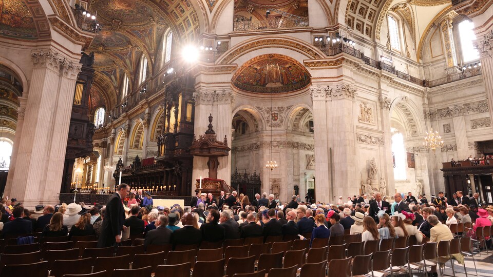 People are sitting in a cathedral.