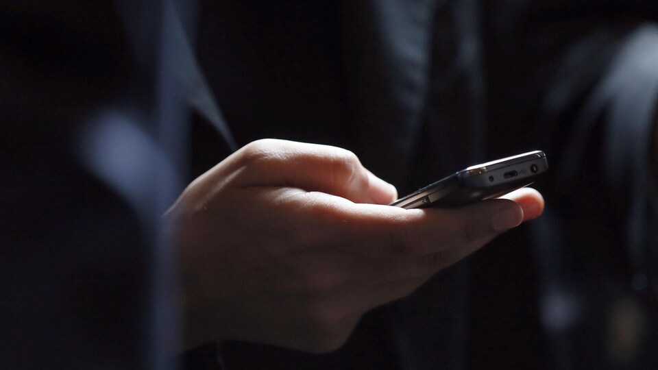 Une personne consulte son téléphone.