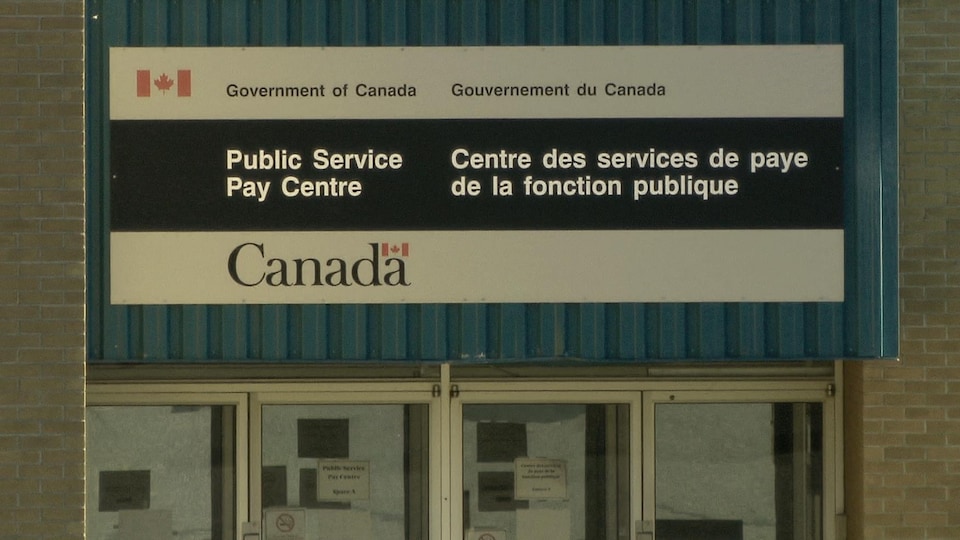Un écriteau annonce l'entrée de l'immeuble.