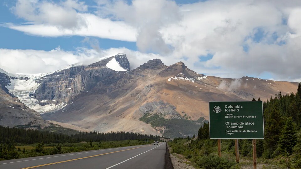 Une montagne et une voiture sur une route du parc national de Jasper