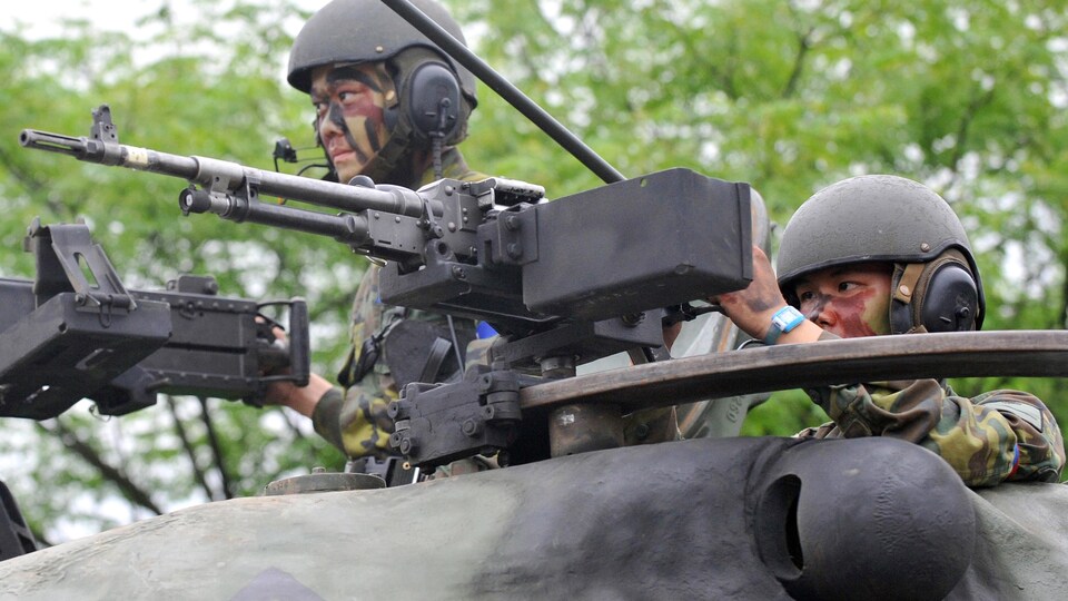 Deux soldats taïwanais en position sur un char d'assaut de fabrication américaine lors d'un entraînement militaire.