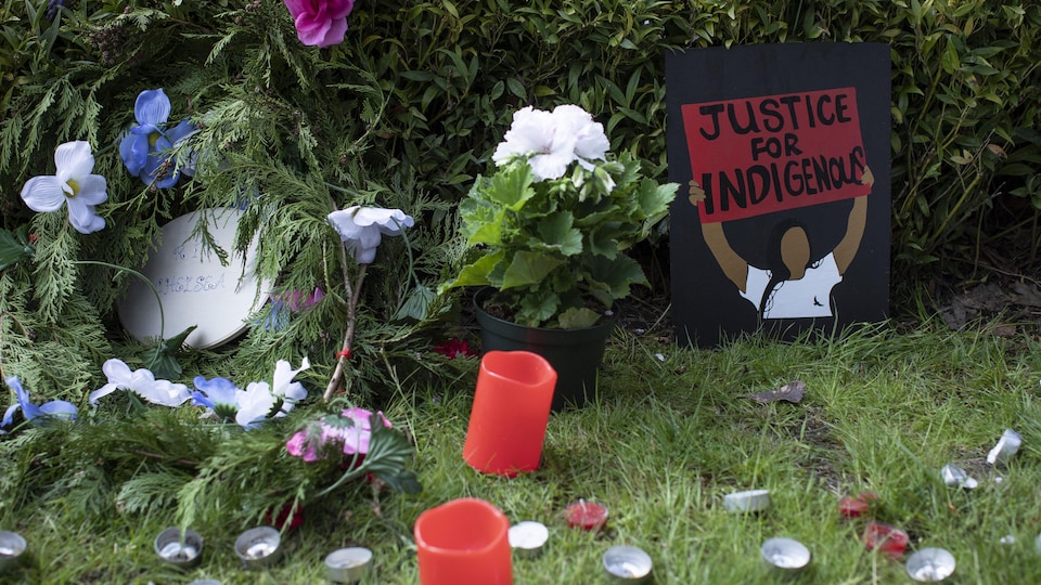 A memorial for Chelsea Poorman, with candles and drawings, outside the home in Vancouver, British Columbia, Tuesday, May 10, 2022.
